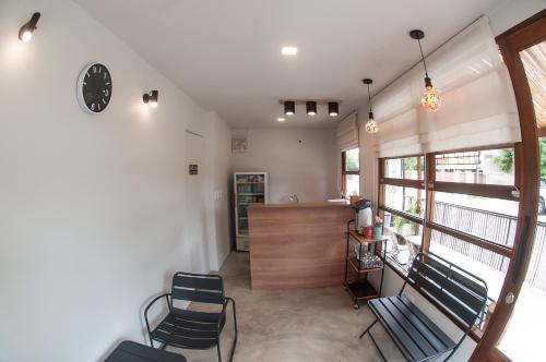 a living room with two chairs and a counter at SLEEP TIGHT at Chumphon in Chumphon