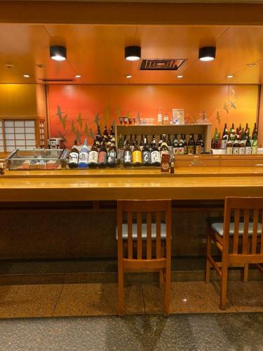 a bar with bottles of alcohol on a counter at Hotel Clio Court Hakata in Fukuoka