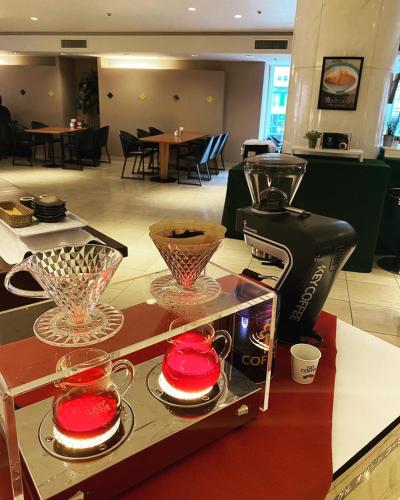 a restaurant with a coffee maker and dishes on a counter at Hotel Clio Court Hakata in Fukuoka