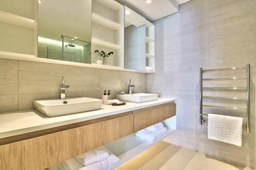 a bathroom with two sinks and a mirror at Rock Villa in Cape Town