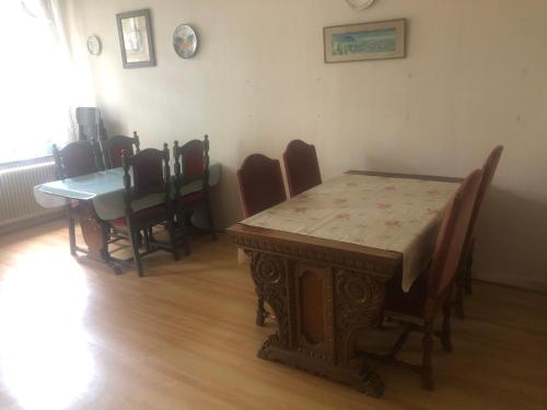 a dining room with a wooden table and chairs at Billingehill Bed&Breakfast in Billinge