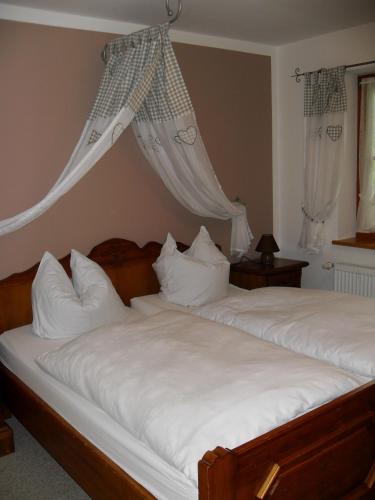 a bedroom with two beds with white pillows at Gasthaus - Pension - Café Dörfl in Kiefersfelden