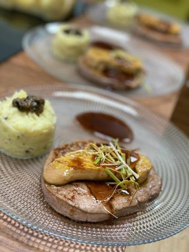 a plate of food on a wooden table at Salon Boyer in Épernay