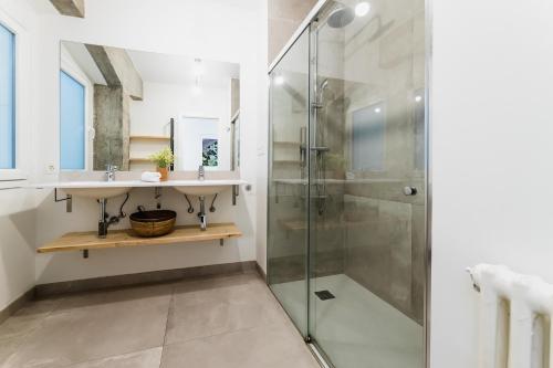 a bathroom with a glass shower and a sink at ZABALETA by SWEET HOME SAN SEBASTIAN in Donostia-San Sebastián