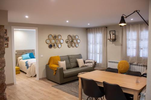 a living room with a couch and a table at Cal Tomaset in Prades