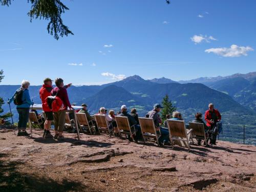 a group of people sitting in chairs on top of a mountain at Apartments Sabine K in Merano