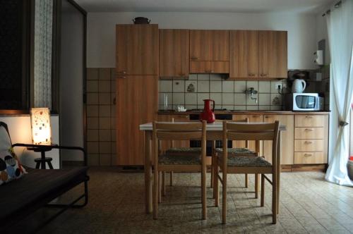 a kitchen with a table and chairs in a room at Il bilocale della nonna in Locana