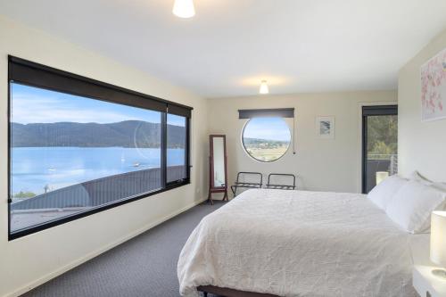 a bedroom with a large window with a large bed at Quarry Hill Lookout in Dover