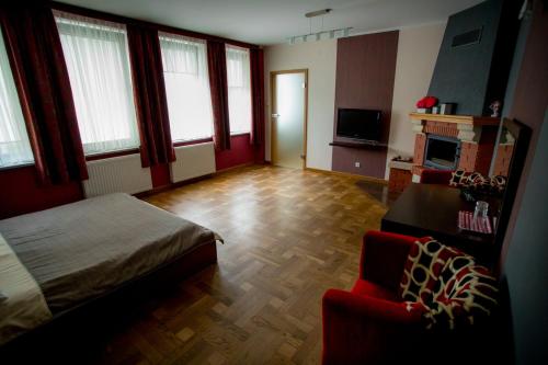a bedroom with a bed and a chair in a room at Restauracja Sonata in Zwierzyniec
