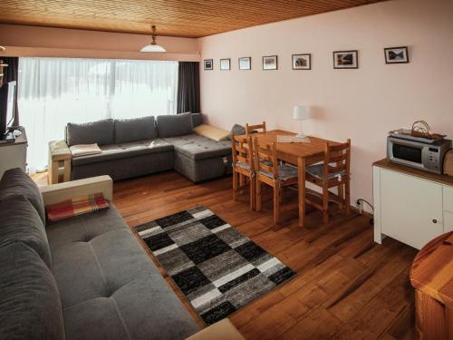 a living room with a couch and a table at Lovely Apartment in Tauplitz