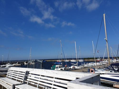 a marina with boats parked in a harbor at Apartament "Złoty relaks" tuż przy plaży z balkonem z widokiem na Hel i hamakami in Puck