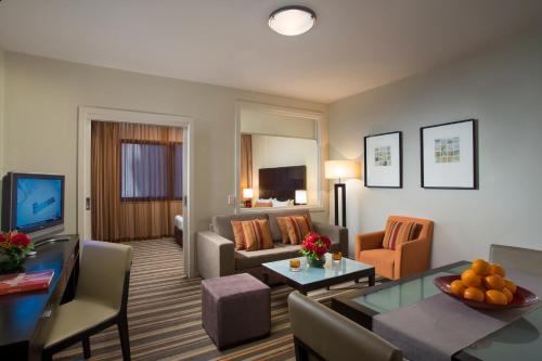 a living room with a couch and a table at Urban Apartments Melbourne on Elizabeth in Melbourne