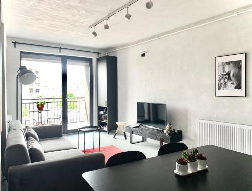 a living room with a couch and a table at Cluj Apartments in Cluj-Napoca