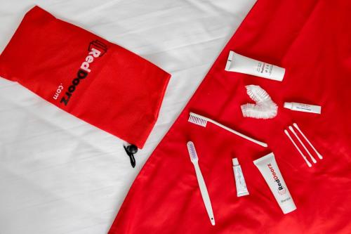 a pair of red pajamas sitting on a bed at RedDoorz Syariah @ Hotel Kencana Tasikmalaya in Tasikmalaya