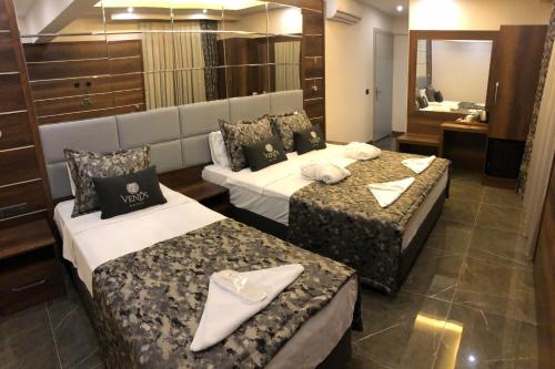 a hotel room with two beds and a bathroom at Venus Hotel in Pamukkale