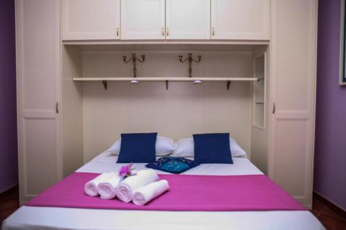 a bedroom with a bed with towels on it at Paoline's suite in villa in Fiumicino