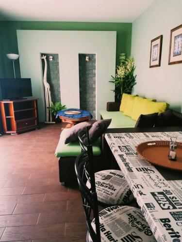a living room with a table and a couch at Apartmány pri Auparku in Piešťany