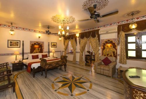 a bedroom with a bed and a desk in a room at Umaid Bhawan - A Heritage Style Boutique Hotel in Jaipur