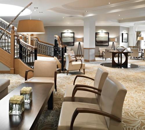 a lobby of a hotel with chairs and tables at Grand Hotel Sunderland in Sunderland