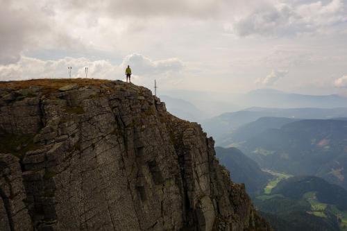 a person standing on the edge of a mountain at Apartments Sabine G in Merano