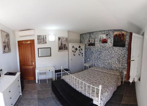 a small bedroom with a bed and a wall at Locanda le Mandriane in Orbetello