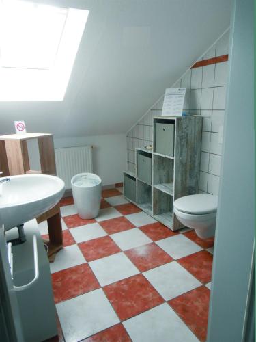 a bathroom with a toilet and a sink at FeWo Nala II in Trier