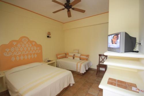 Hotel Maria Mixteca tesisinde bir odada yatak veya yataklar