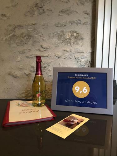 a bottle of wine sitting on a table next to a box at Gîte du Parc des Mauves in Meung-sur-Loire