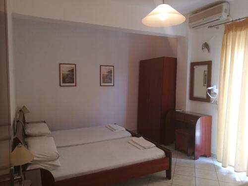 a small bedroom with a bed and a window at Villa Anna in Hanioti