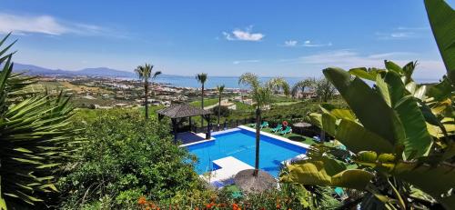 a swimming pool with a view of the ocean at Apartamentos Manilva Green in Manilva