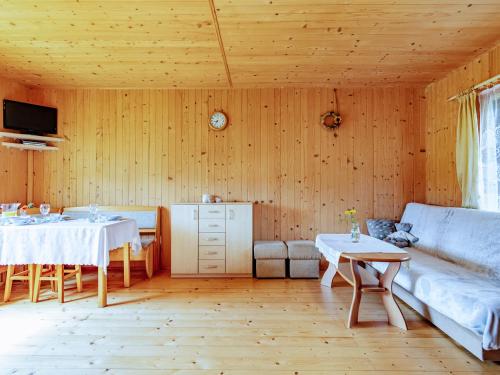 a living room with two tables and a couch at Domki Victoria in Ustka