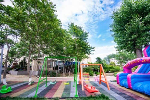 a playground with colorful equipment in a park at Hotel & MedSpa Siret in Mamaia