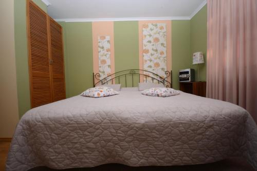 a bedroom with a bed with a white comforter at Agroturystyka U Tadysa in Szaflary