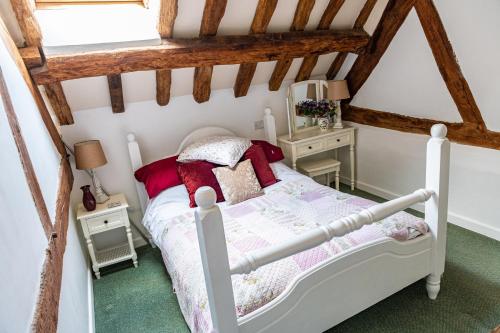 a bedroom with a bed in a attic at The Old Farm in Gloucester