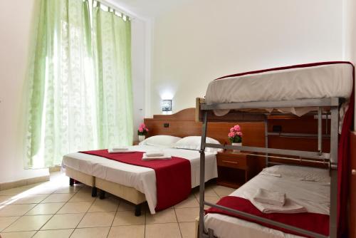 a bedroom with two bunk beds and a window at B&B Termini in Rome