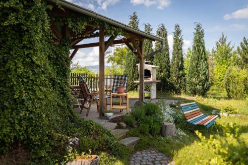 a gazebo with chairs and a table in a garden at Pension Vetrny Vrch in Ostrov