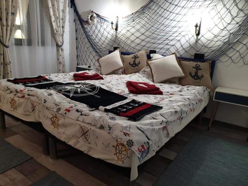 a bed with a white comforter and pillows on it at Delta MAYANKA in Mineri
