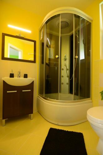 a bathroom with a shower and a sink at STOP&RELAX Apartment in Liptovská Osada