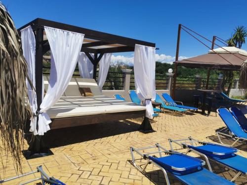 a bed and chairs on a patio at Sidari Waterpark in Sidari