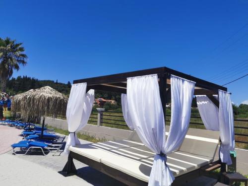 a group of lounge chairs and umbrellas on a beach at Sidari Waterpark in Sidari