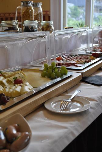a buffet with many different types of food on a table at Hotel & Chalets Herrihof in Todtnauberg