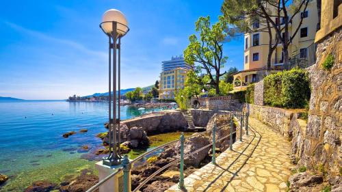 a street light next to a body of water at Apartment Adriana in Opatija