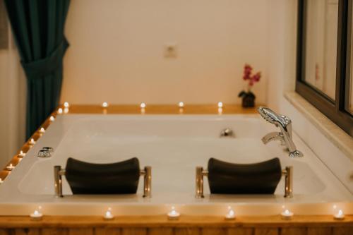 two chairs sitting in a bath tub with lights at MULBERRY SUİT APART in Kaş