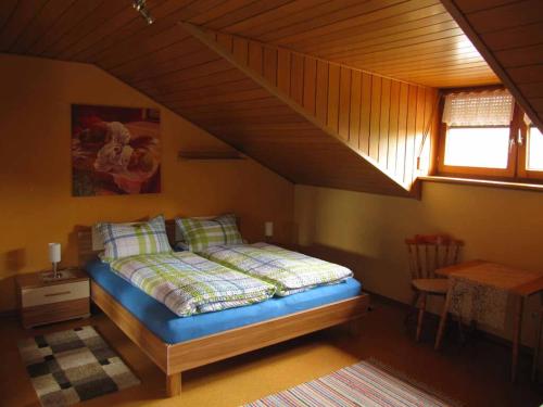a bedroom with a bed in a attic at Ferienwohnung Kreuzer Lydia in Furth im Wald