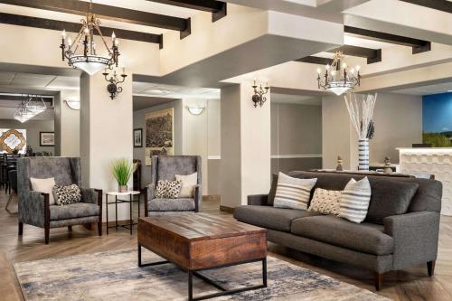 a living room with a couch and two chairs at La Quinta by Wyndham Trinidad in Trinidad
