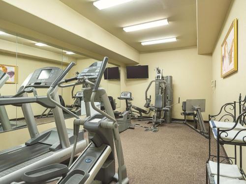 a gym with treadmills and elliptical machines at La Quinta by Wyndham Trinidad in Trinidad