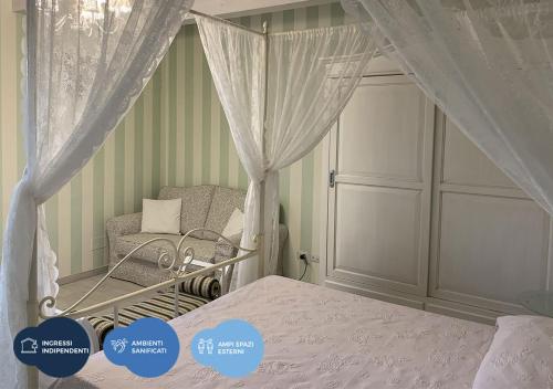 a bedroom with a canopy bed and a chair at Ca' Del Conte in Padula