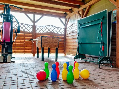 a group of colorful bowling pins sitting on the floor in a room at Domki Victoria in Ustka