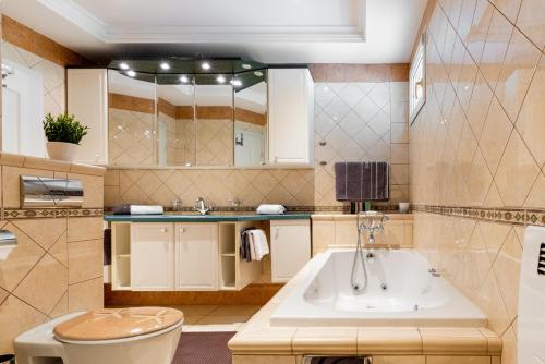 a bathroom with a tub and a sink at Villa Katarina in Labin