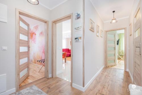 korytarz z drzwiami prowadzącymi do pokoju w obiekcie Wyspa Solna City Center by Jantar Apartamenty Kołobrzeg w Kołobrzegu